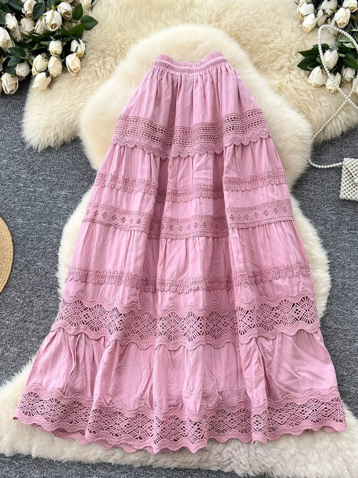 Pink lace dress on a textured surface with floral decorations