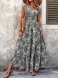 Woman wearing a floral dress standing against a textured wall.
