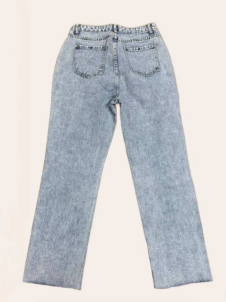 Light blue jeans on a beige background