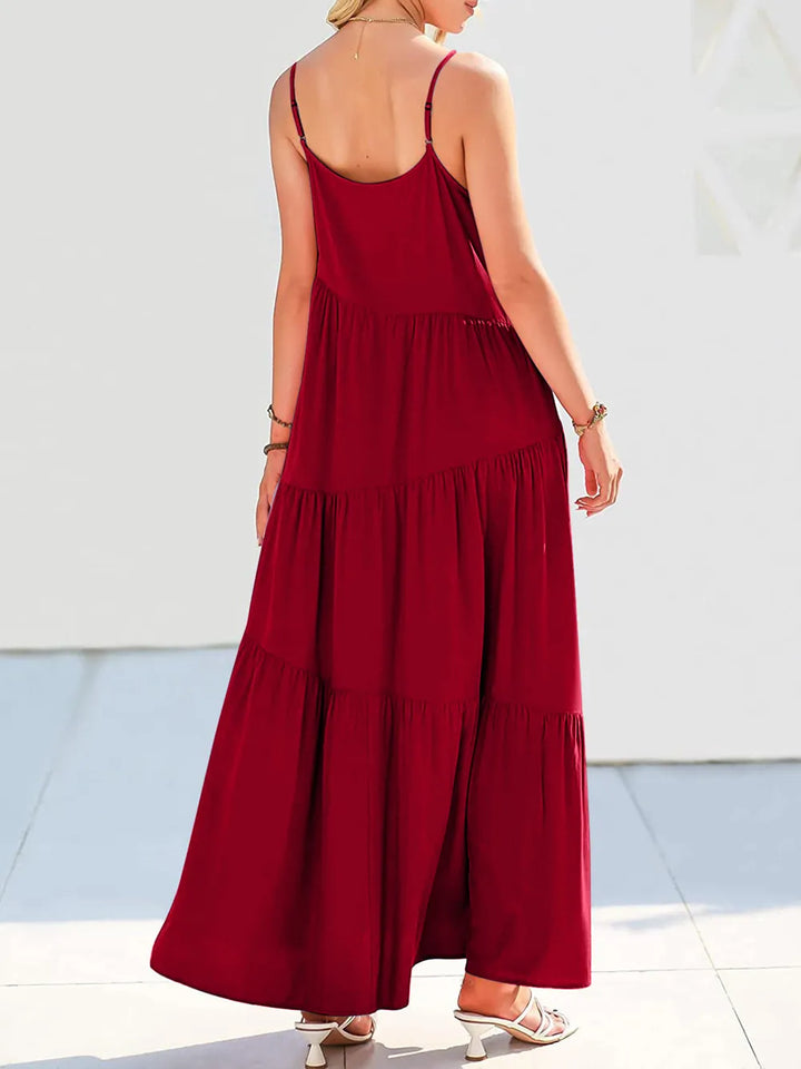 Red dress with thin straps worn by a person on a light background