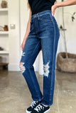 Person wearing blue jeans with slight distressing in a casual setting.