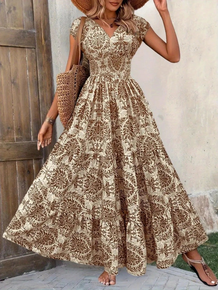 Woman wearing a floral dress standing against a wooden door.