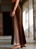 Brown dress with sheer panels worn by a person indoors