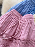Close-up of pink shorts with lace trim and blue shorts in the background.