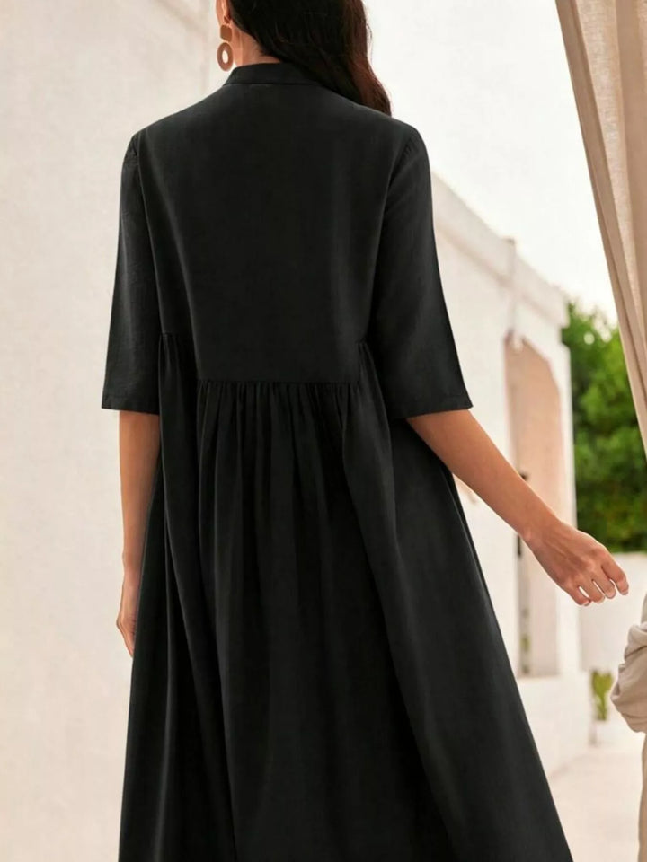 Person wearing a black dress with a blurred background