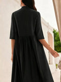 Person wearing a black dress with a blurred background
