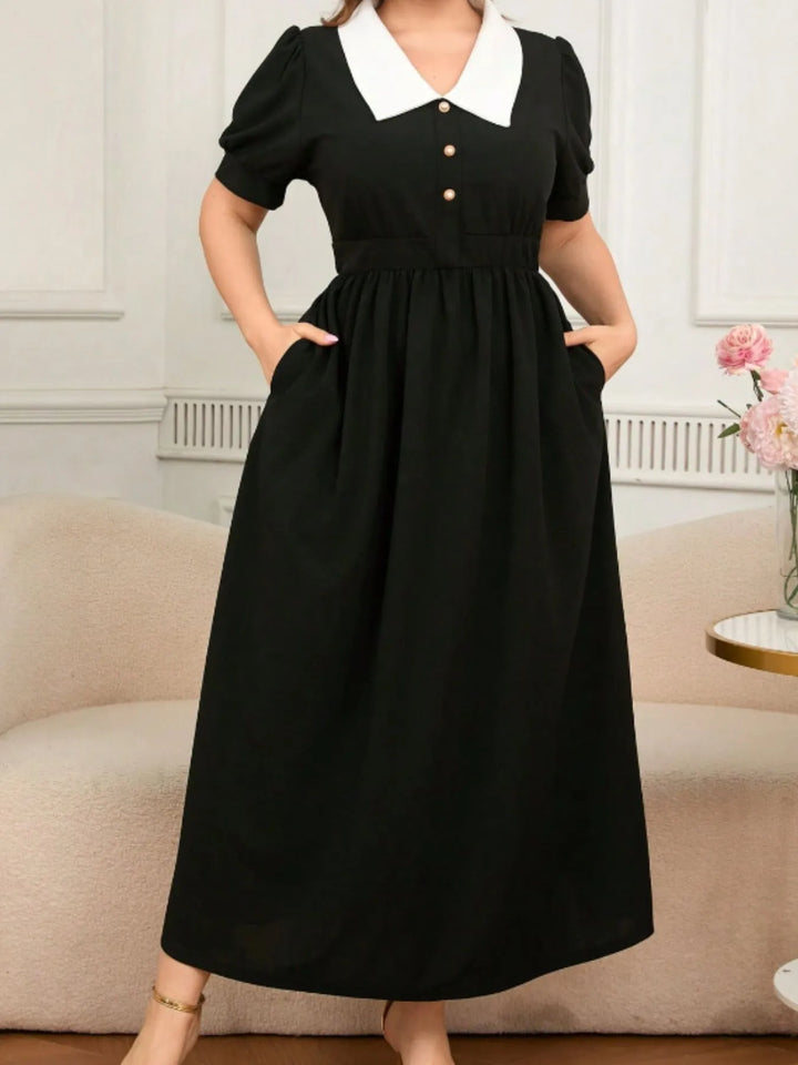 Black dress with white collar worn by a person in an indoor setting
