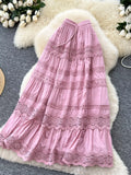 Pink lace dress on a textured surface with floral decorations