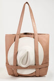 Brown tote bag with a white cylindrical object inside on a light gray background