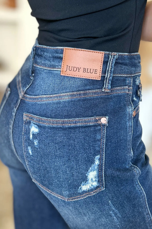Close-up of blue jeans with a Judy Blue label on the back pocket.