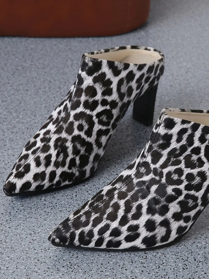 Leopard print high-heeled shoes on a gray surface