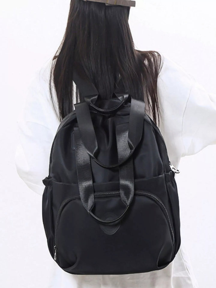 Black backpack with a large bow on a white background