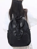 Black backpack with a large bow on a white background
