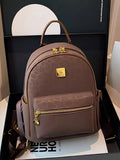 Brown backpack with gold accents on a white surface