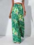 Green leaf-patterned pants worn by a person on a gray background
