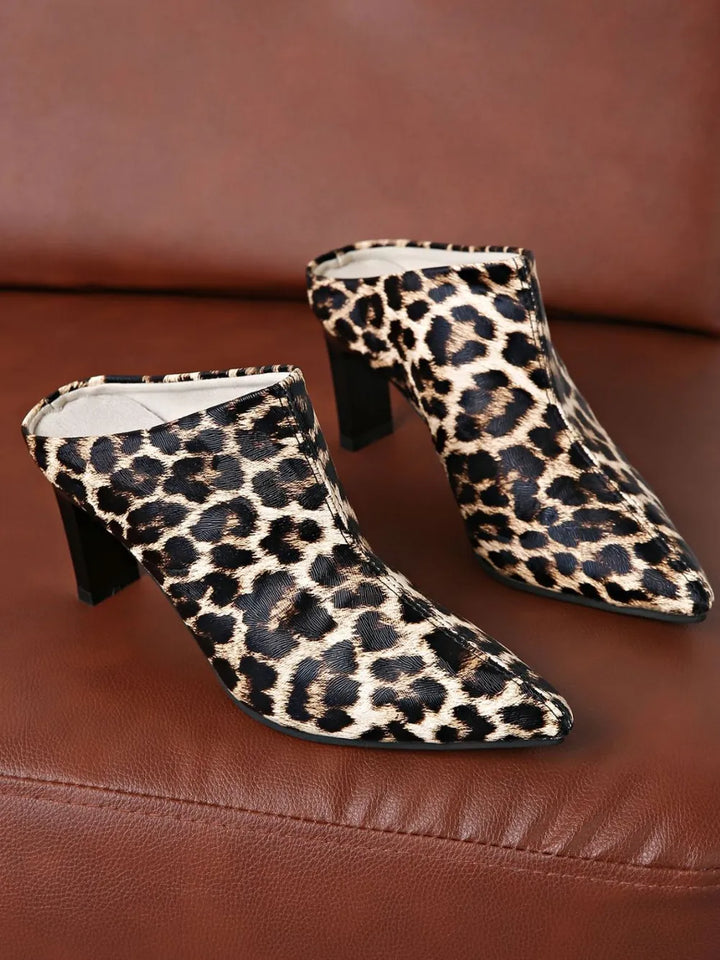 Leopard print high-heeled shoes on a brown surface