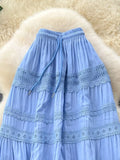 Light blue skirt with lace details on a fluffy white surface