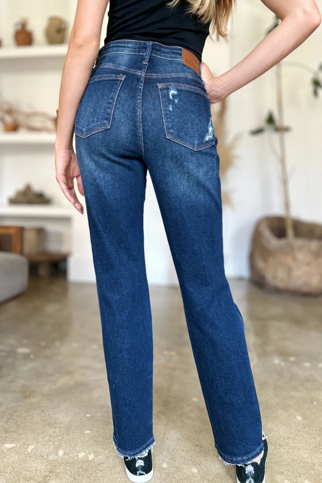 Person wearing blue jeans indoors with a blurred background