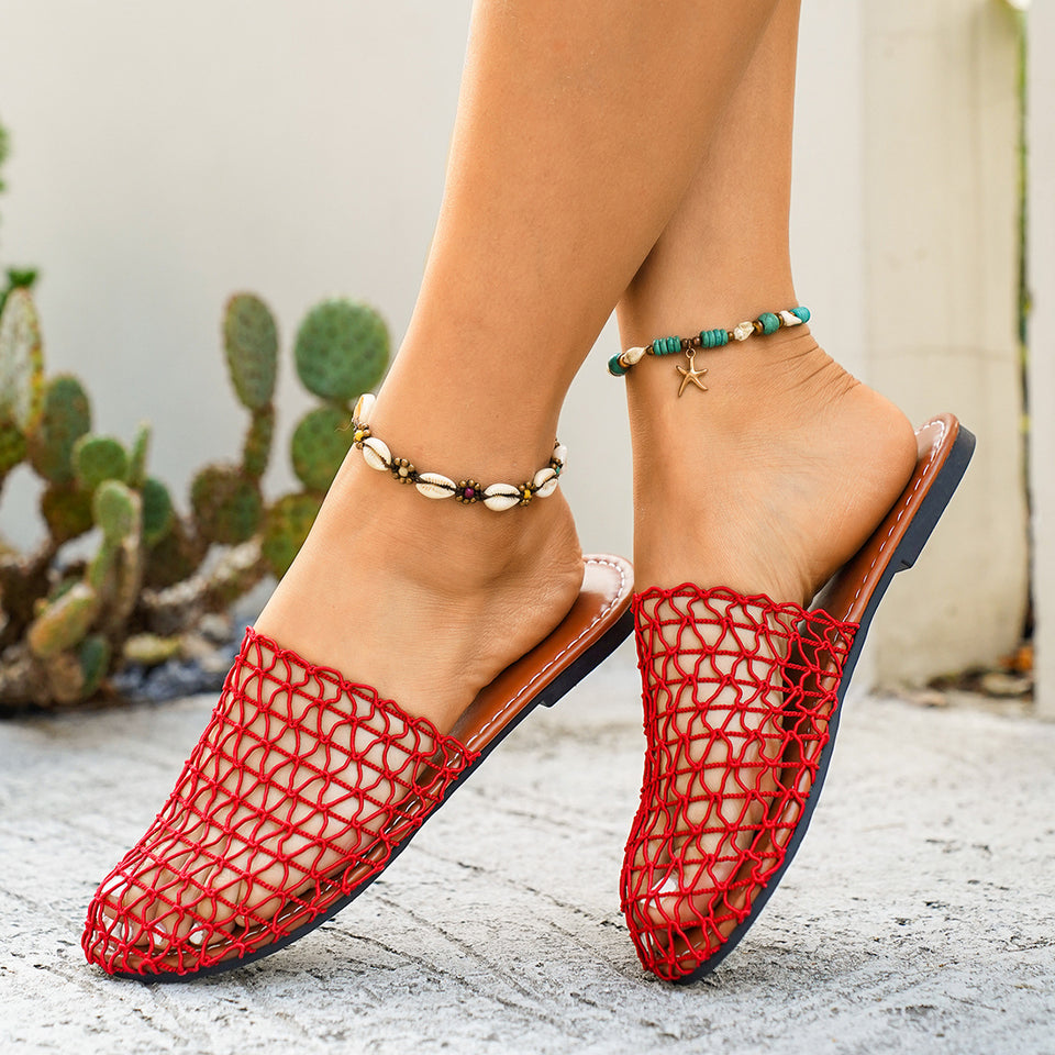 Red mesh sandals worn with a neutral background