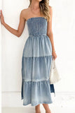 Woman wearing a strapless denim dress with a white background
