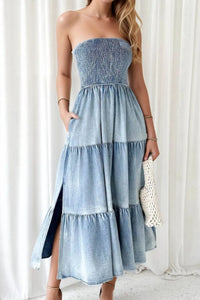 Woman wearing a strapless denim dress with a white background