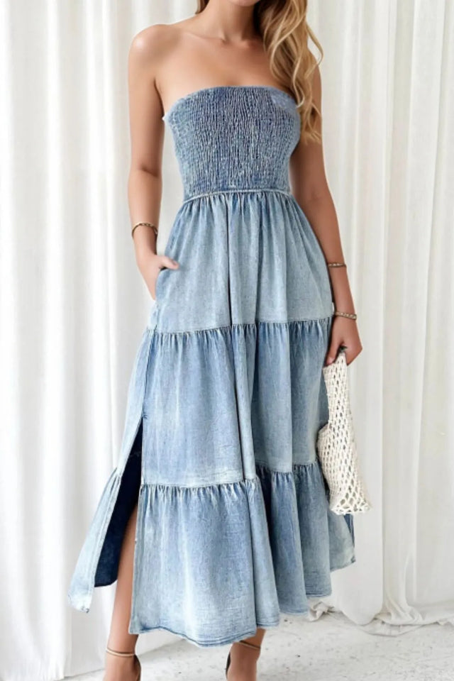 Woman wearing a strapless denim dress with a white background