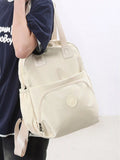 Beige backpack held by a person against a white background