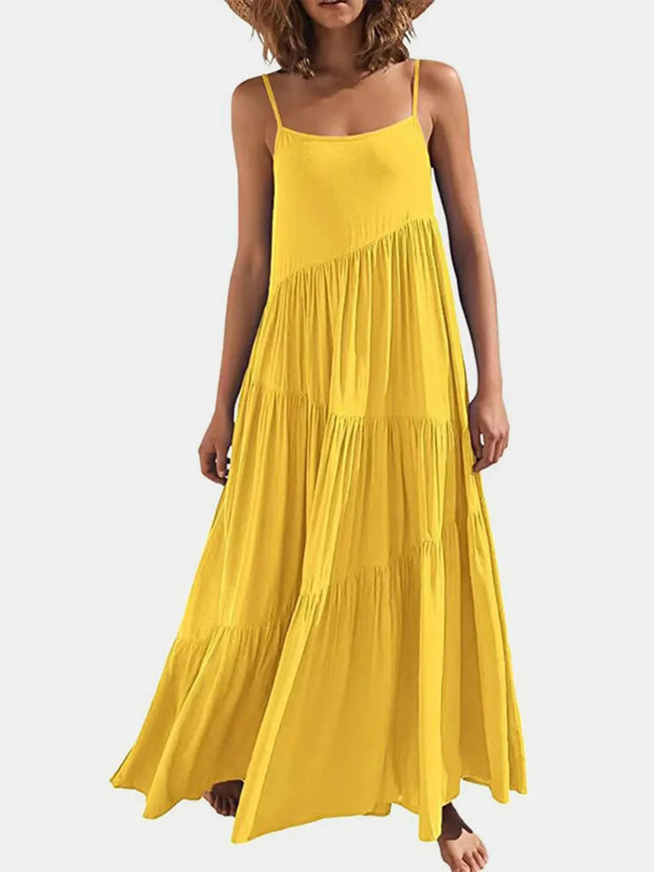 Woman wearing a yellow maxi dress on a white background