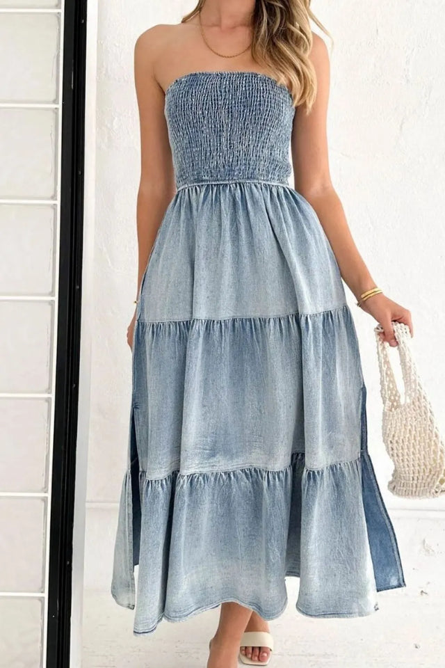 Woman wearing a strapless denim dress with a white background