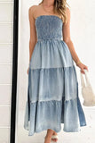 Woman wearing a strapless denim dress with a white background