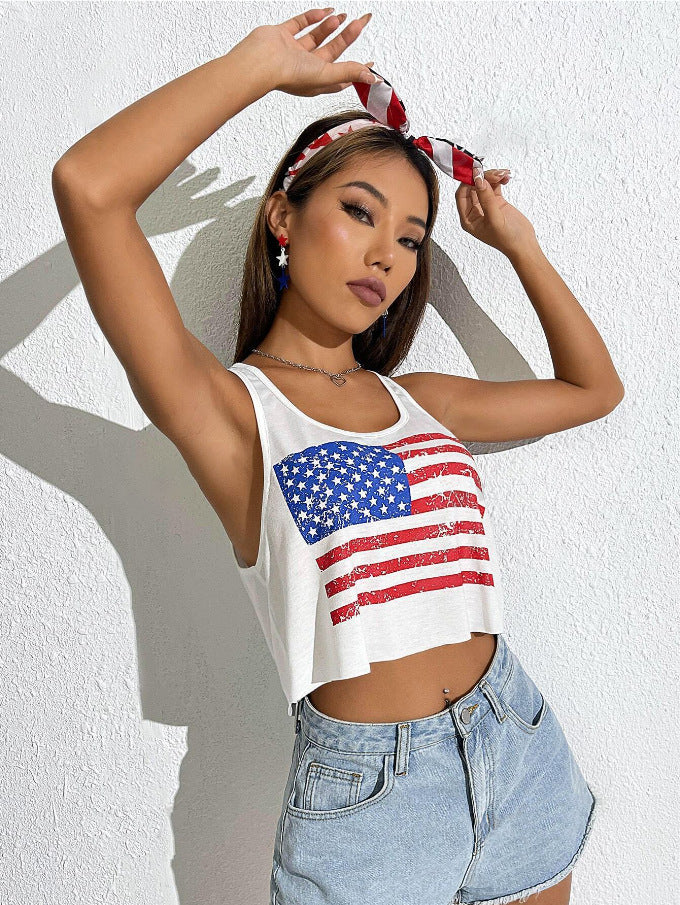 Woman wearing a white tank top with an American flag design against a light background
