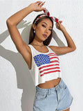 Woman wearing a white tank top with an American flag design against a light background