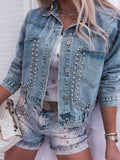 Denim jacket with studded details worn by a person, with a white background.