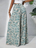 Person wearing green leaf-patterned pants on a neutral background