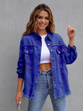 Woman wearing a blue denim jacket over a white top and jeans against a gray background