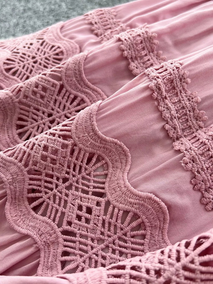 Close-up of a pink lace garment with intricate patterns.
