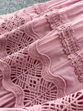 Close-up of a pink lace garment with intricate patterns.