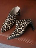 Leopard print high-heeled shoes on a brown surface