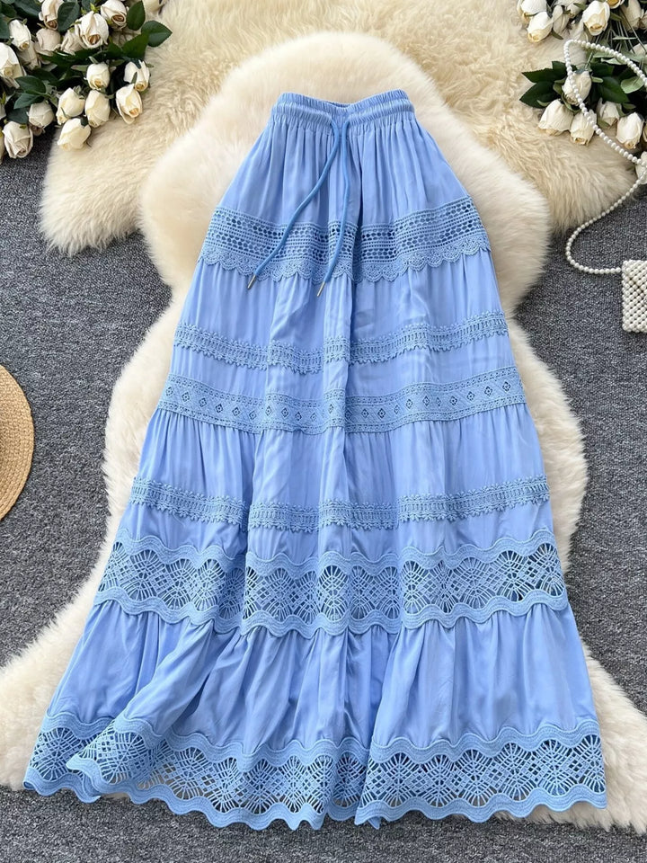 Blue lace dress on a textured surface with decorative elements