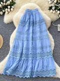 Blue lace dress on a textured surface with decorative elements