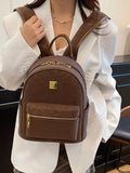 Person wearing a brown backpack with a visible brand logo.