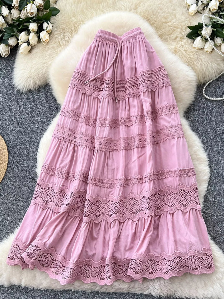 Pink lace dress on a textured surface with floral decorations