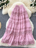 Pink lace dress on a textured surface with floral decorations