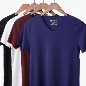 Blue t-shirt on a hanger with other colored shirts in the background