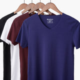 Blue t-shirt on a hanger with other colored shirts in the background
