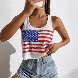 Person wearing a white tank top with an American flag design against a plain background