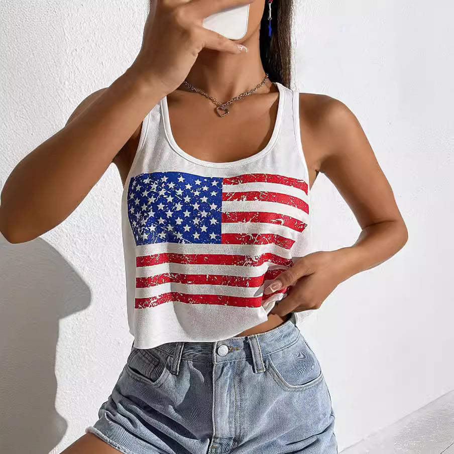 Person wearing a white tank top with an American flag design against a plain background