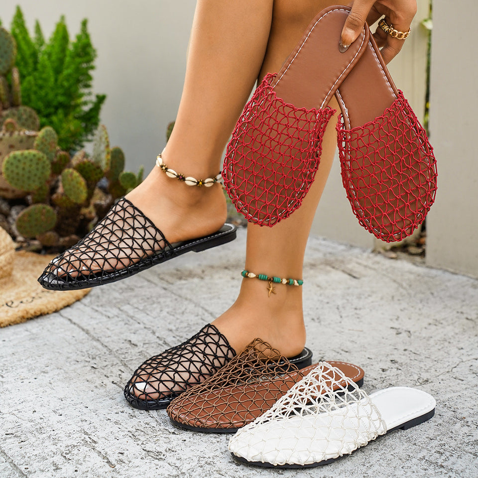 Person wearing black, brown, and white mesh sandals with a cactus plant in the background.